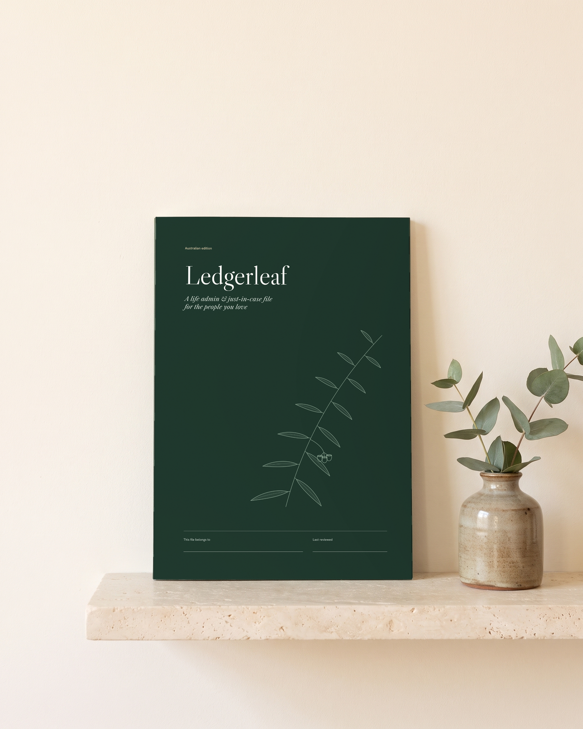 Ledgerleaf life admin and just-in-case file standing on a shelf beside eucalyptus