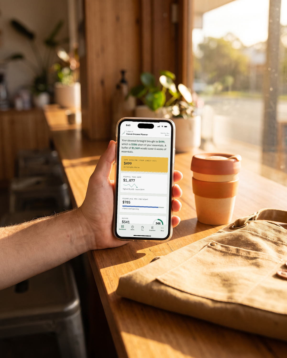 Casual Income Planner open on a phone beside a coffee cup in morning light