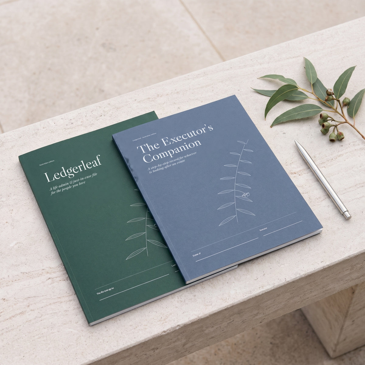 Ledgerleaf and The Executor's Companion side by side on a pale stone bench